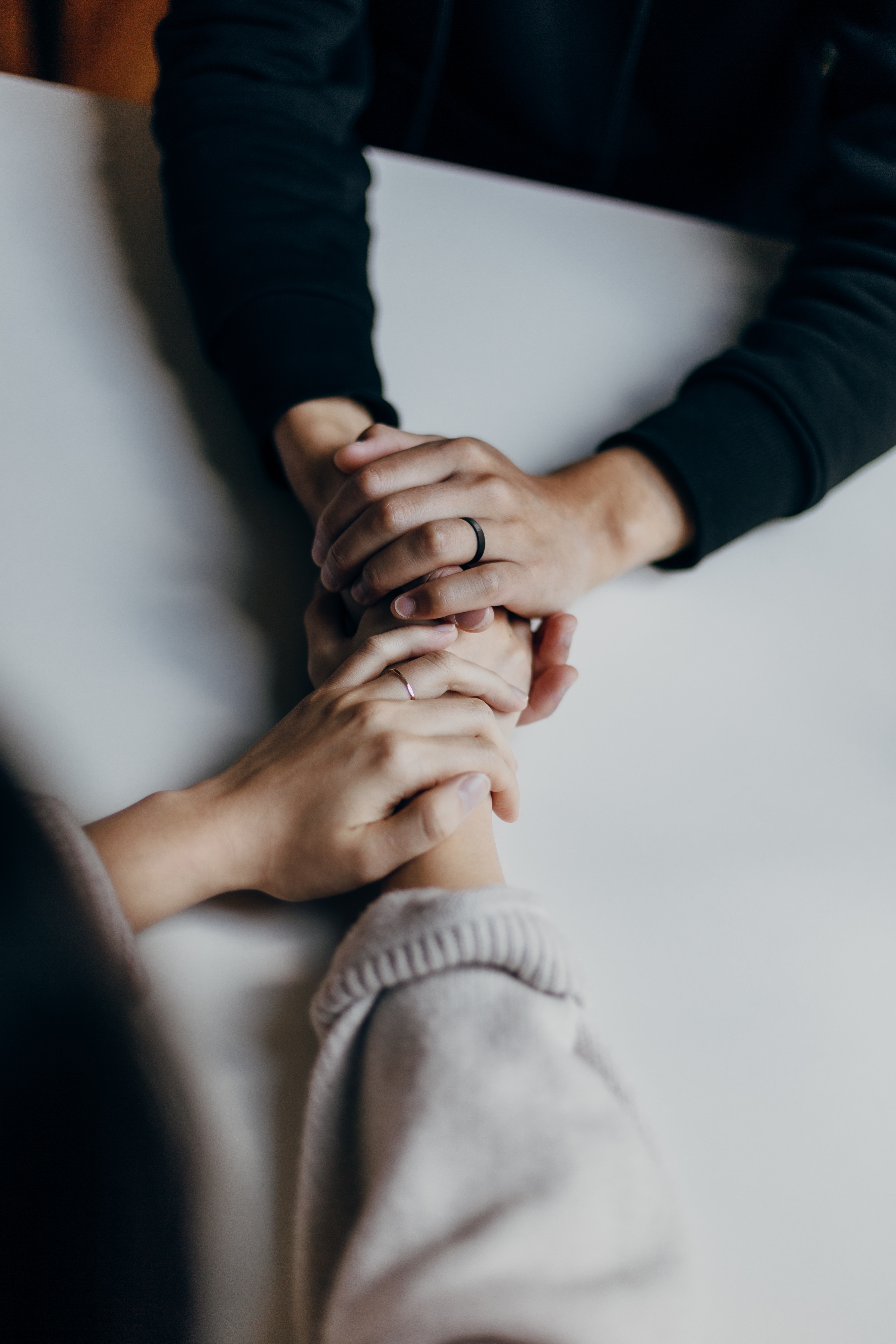 Supportive hands representing care and counseling for individuals experiencing baby blues or postpartum depression at Aura Birthing Partner